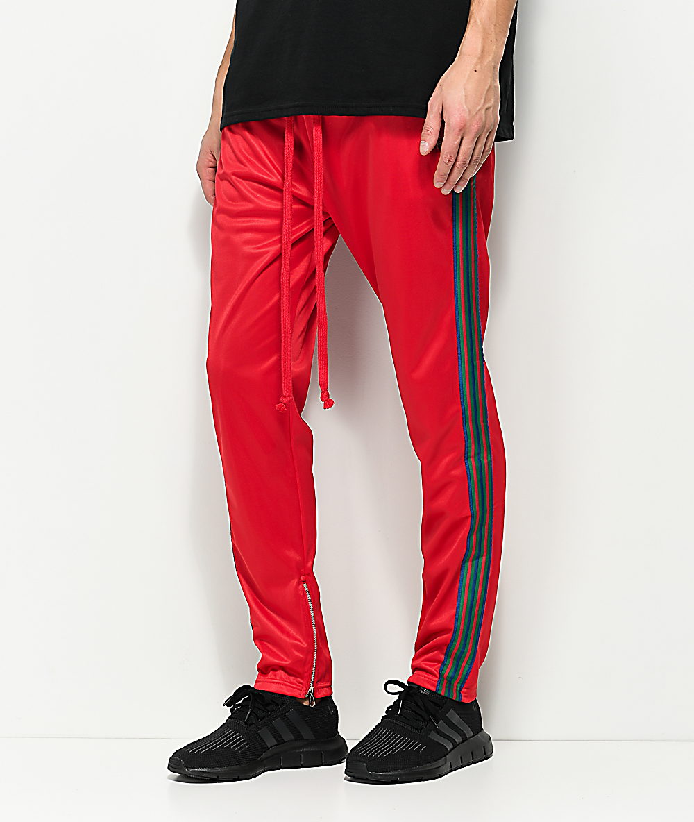 green track pants with red stripe