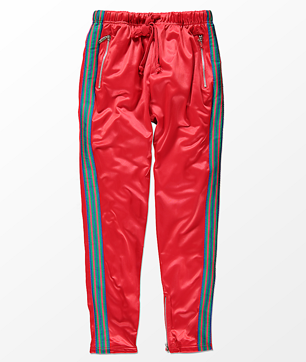 green track pants with red stripe