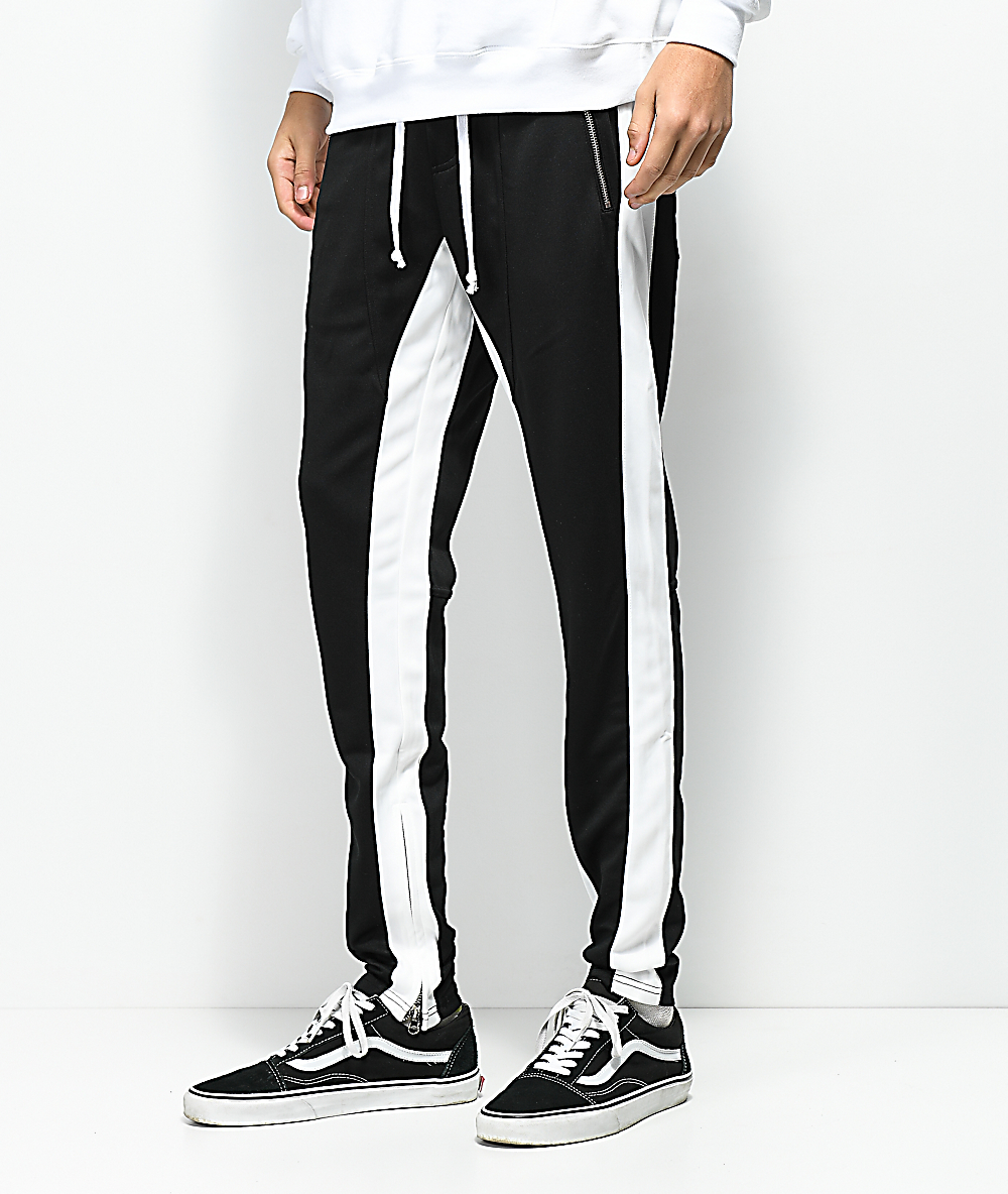 black track pants with yellow stripe