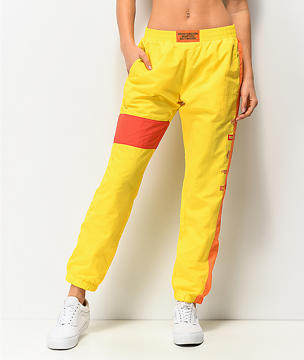 red and yellow track pants