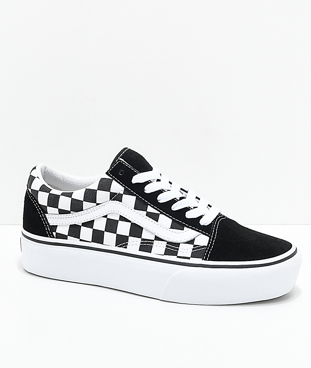 black and white checkerboard vans near 