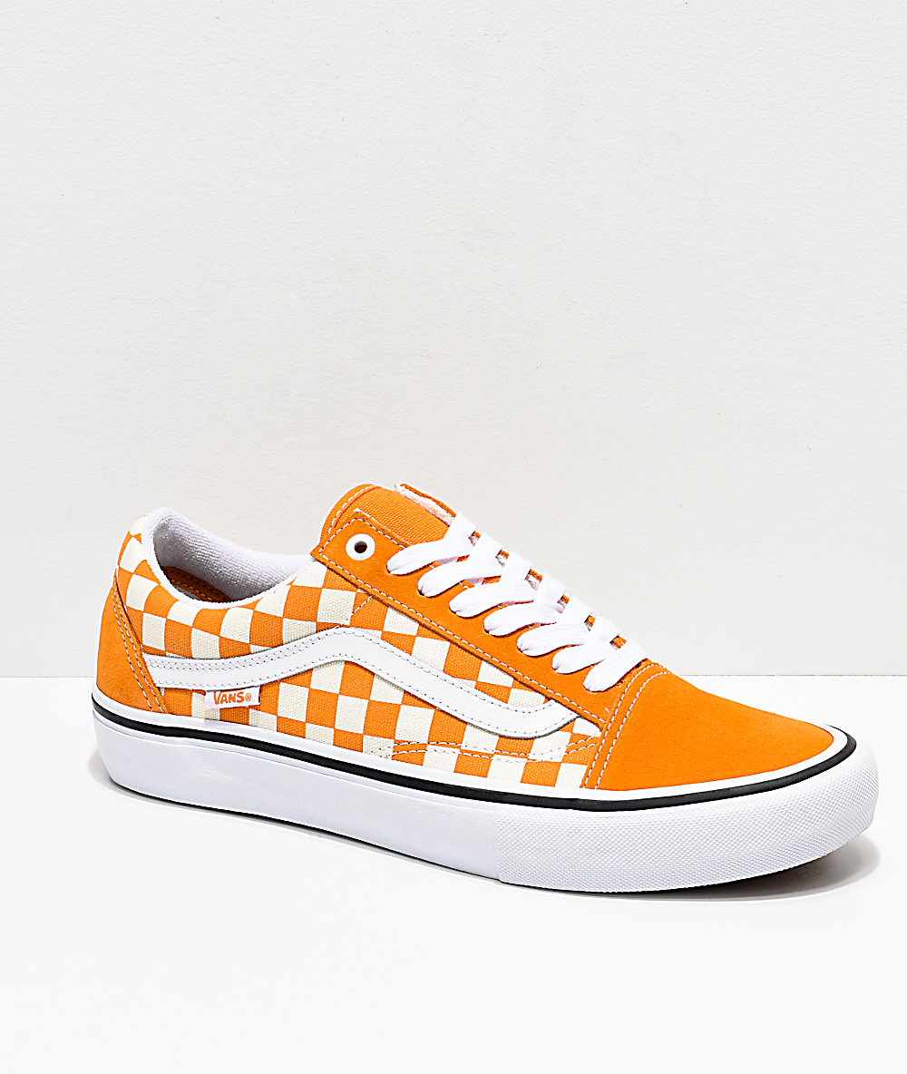 orange checkerboard slip on vans