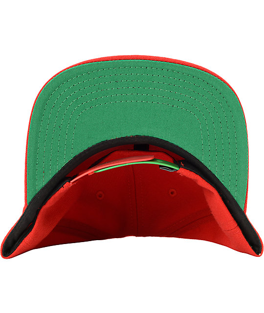 red and green baseball hats