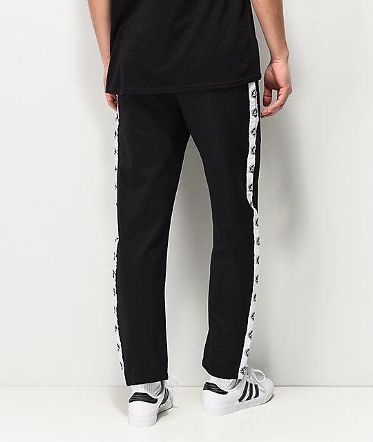 black track pants with yellow stripe