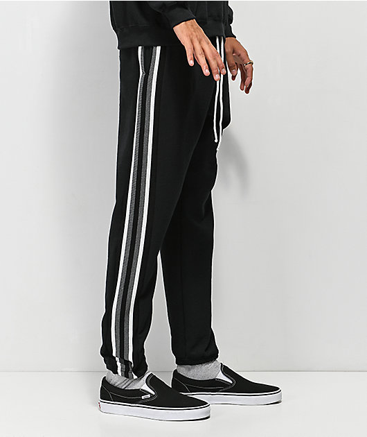 black sweats with white stripes