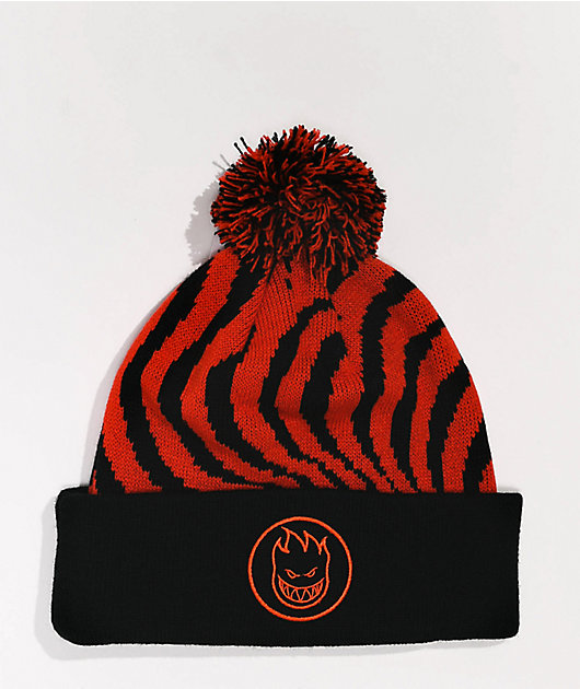 black beanie with red pom pom