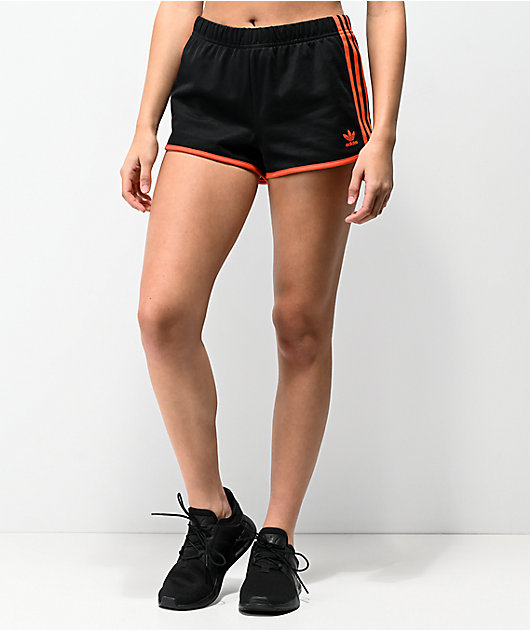 black adidas with orange stripes